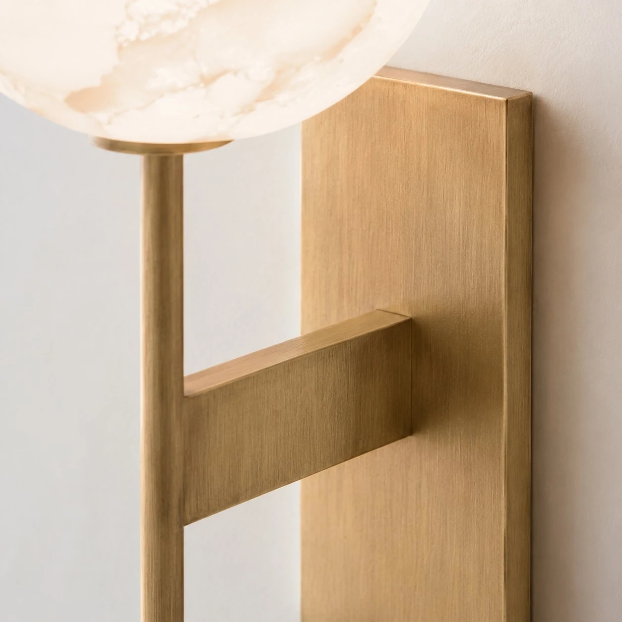 Natural brass arm and wall plate detail