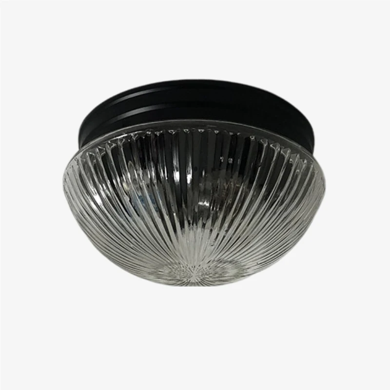 Paralume in vetro trasparente a coste con rosone a soffitto nero.