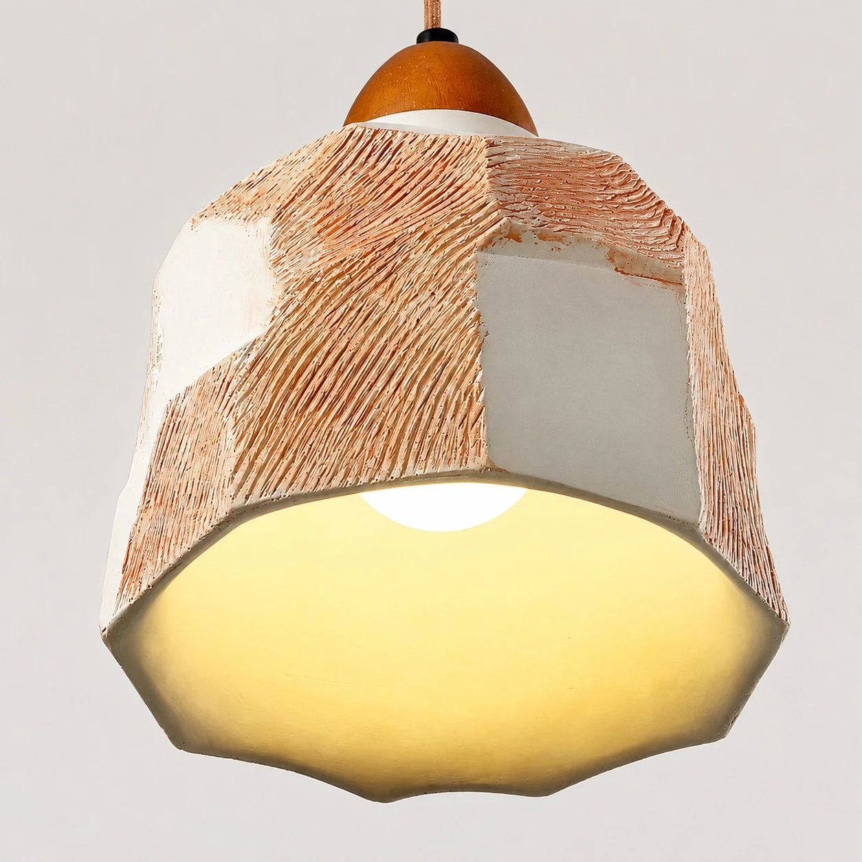 Warm light glow beneath the faceted pendant shade